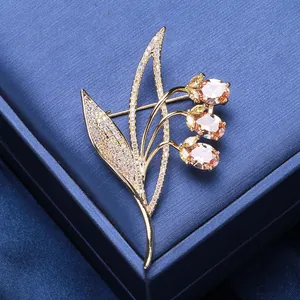 Detailed close-up of elegant flower brooch with champagne gems and pavé zircon settings