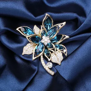 Macro detail of luxury blue crystal flower brooch with cubic zirconia on silk
