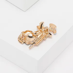 Detail view showing the golden alloy brooch back structure with secure needle clasp