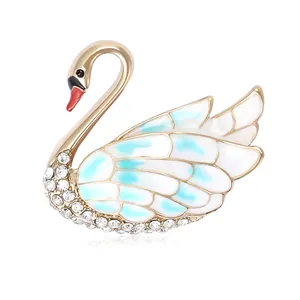 Elegant swan brooch with blue enamel wings and sparkling rhinestones for women