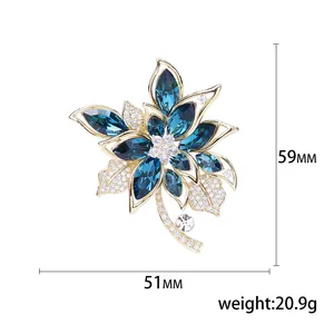 Elegant floral copper brooch with blue zircon crystals and pave-set rhinestones