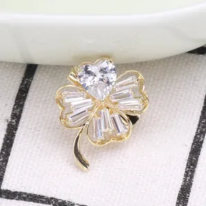 Elegant four-leaf clover brooch in gold finish with sparkling zircon stones and heart center
