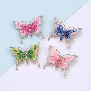 Detail of four colorful butterfly brooches with crystal inlay and enamel finish on alloy