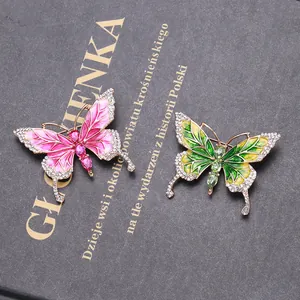Close-up of luxury enamel butterfly brooches with rhinestones and rose gold plating