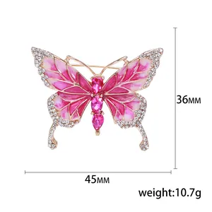 Elegant gold-tone butterfly brooch with pink enamel and crystals, 45mm x 36mm size