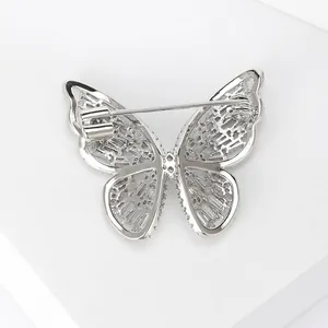 Detail view showing silver butterfly brooch back with secure metal pin fastener