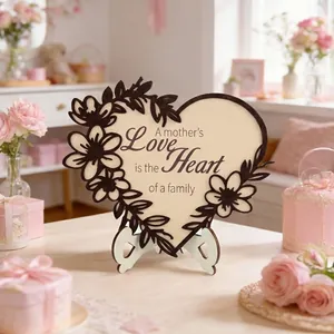 Close-up of heart-shaped wooden plaque with floral laser-cut edges and warm quote for Mother's Day