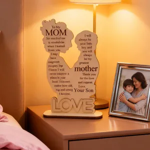 Macro view of wooden Mother's Day carving with silhouettes and engraved poem detail