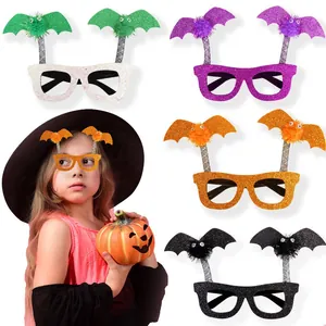 Detail showing five glitter Halloween bat glasses with colorful pompoms and cartoon eyes