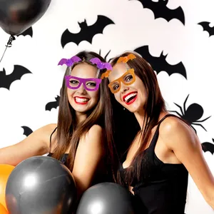 Glittery Halloween bat party glasses in purple and orange worn by models for festive decor