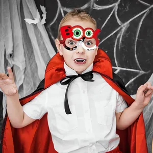 Λεπτομέρεια παιδικής στολής Halloween με κόκκινη μαύρη κάπα και γυαλιά κολοκύθας BOO!