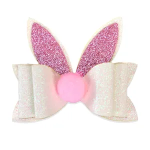 Fermaglio orecchie di coniglio pasquale con fiocco glitterato bianco e pompon rosa