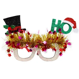 Macro view of Christmas glitter glasses with gold tassels and star-shaped sequins