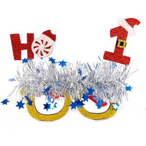 Detailed view of festive Christmas party glasses with silver tassels and Santa ornament