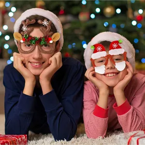Kids wearing festive Christmas glasses with reindeer antlers and Santa hat designs