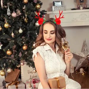 Close-up of a Christmas reindeer antler headband with bells on a woman at a party