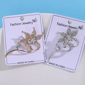Sparkling rhinestone flower brooch available in gold and silver plating with crystal accents