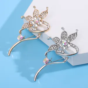 Elegant gold and silver flower brooches with sparkling zircon crystals for formal wear