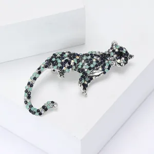 Vintage leopard brooch with colorful rhinestones on a silver metal setting for suits