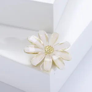 Broche marguerite élégante en acrylique blanc et centre doré sur socle épuré