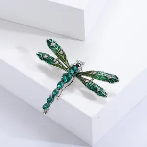 Elegant green enamel dragonfly brooch with sparkling rhinestones and silver alloy finish