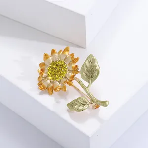 Élégante broche tournesol en émail avec cristaux jaunes sur un bloc d'affichage