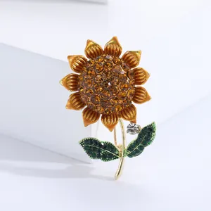 Sunflower brooch with amber rhinestones and green enamel on a golden alloy base