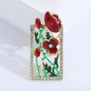 Golden enamel flower brooch with red poppy design and white sparkling rhinestones
