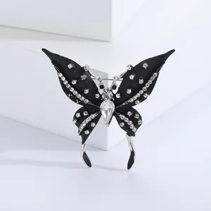 Elegant black butterfly brooch with silver edges and white crystal rhinestones for suits