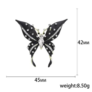 Elegant matte black butterfly brooch with crystals and gold plating, 45mm width