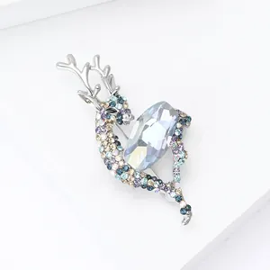 Detailed view of luxury deer brooch featuring gradient colorful crystals and blue main stone