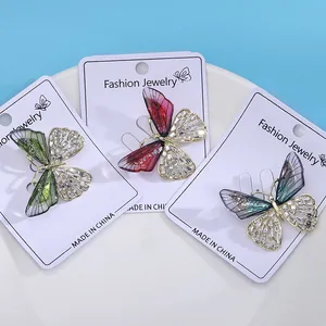 Three gradient rhinestone butterfly brooches in green, pink and purple on gold plating