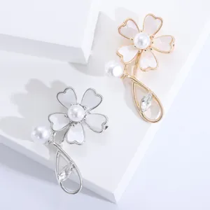 Elegant shell flower brooch with white petals and pearls on gold and silver bases