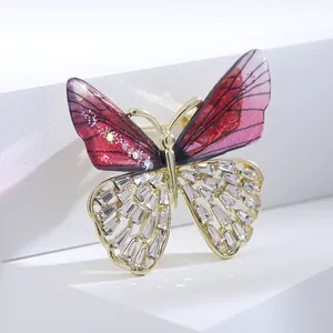 Elegant gradient rhinestone butterfly brooch with golden hollow wings and red accents