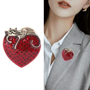 Cartoon alloy cat on red heart brooch with gold finish and green gemstone eyes for women