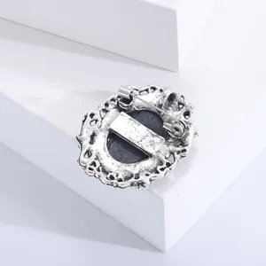 Detailed back view of vintage silver relief brooch with pin and clip closure mechanism