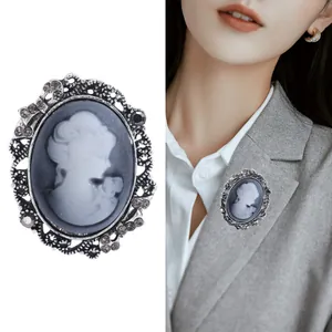 Vintage oval cameo brooch with female silhouette, silver alloy frame and rhinestones