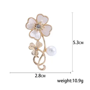 Elegant gold flower brooch with shell petals, rhinestones and pearl, 5.3cm x 2.8cm
