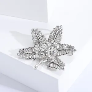 Close-up of Baroque maple leaf brooch with silver alloy and sparkling rhinestones