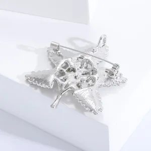 Detailed back view of silver baroque star brooch featuring dual-use pin and pendant loop
