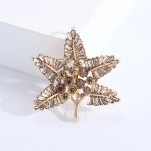 Detailed view of Baroque gold-tone leaf brooch with brown and champagne rhinestones