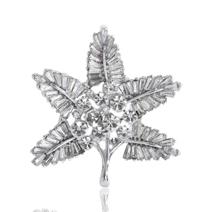 Elegant baroque leaf brooch with sparkling crystals and silver base on white background