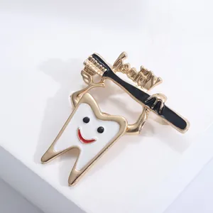Macro detail of cartoon tooth and toothbrush enamel brooch with Healthy text
