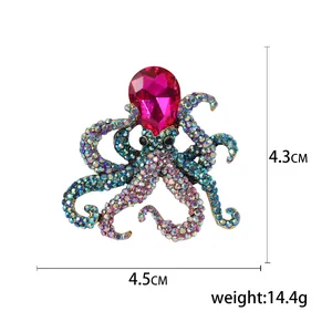 Vintage octopus brooch with colorful rhinestones and pink teardrop gem on white base