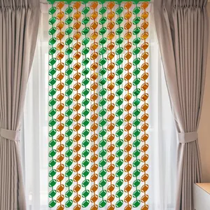 Close-up of green and brown football-shaped tinsel fringe curtain for party backdrops
