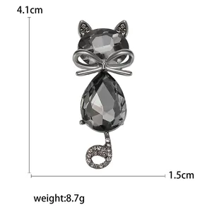 Fashion crystal cat brooch with grey gemstones and white rhinestones on white background