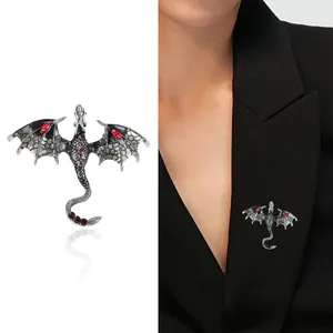 Gothic pterodactyl dragon brooch with red crystals on silver-tone textured alloy