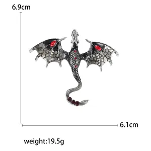 Silver-toned pterodactyl dragon brooch with red gemstones, dimensions 6.9cm x 6.1cm