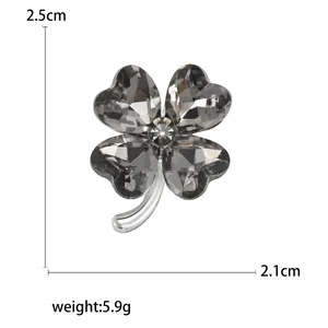 Elegant four-leaf clover brooch with dark heart-shaped crystals and silver metal base