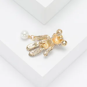 Detailed back view of a gold rhinestone bear brooch showing the secure safety pin clasp